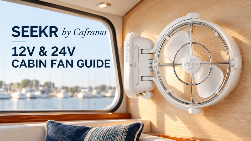 White SEEKR by Caframo Sirocco II cabin fan mounted on a wooden boat interior wall beside a marina-facing window