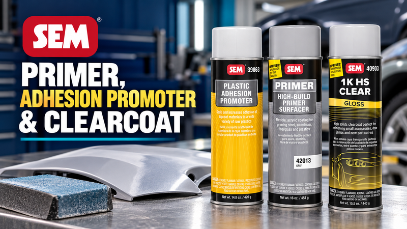 SEM plastic adhesion promoter, gray high-build primer surfacer and gloss clearcoat cans beside a prepared automotive panel