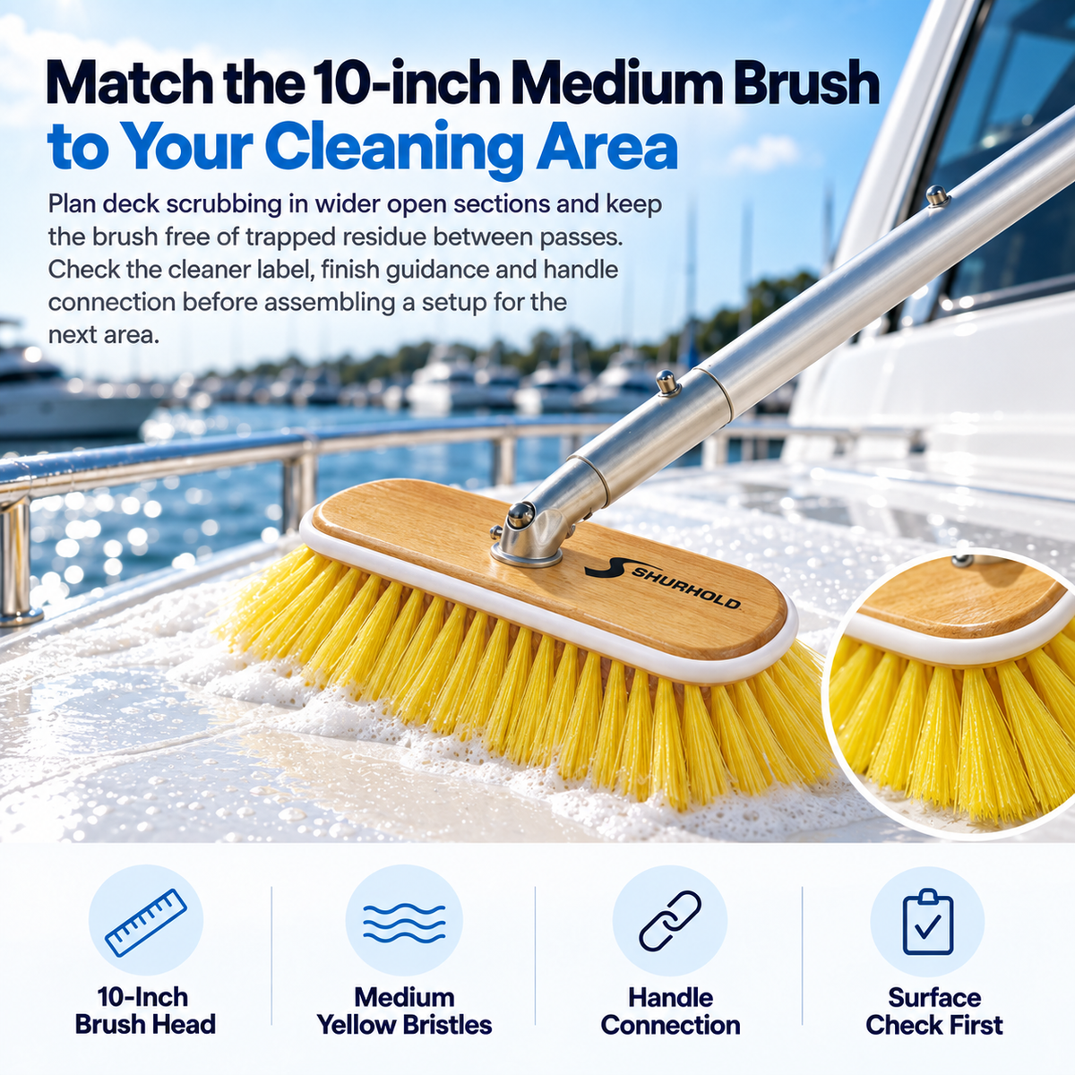 Shurhold 985 10-inch medium-bristle brush with a wooden head and yellow bristles scrubbing a white boat deck.
