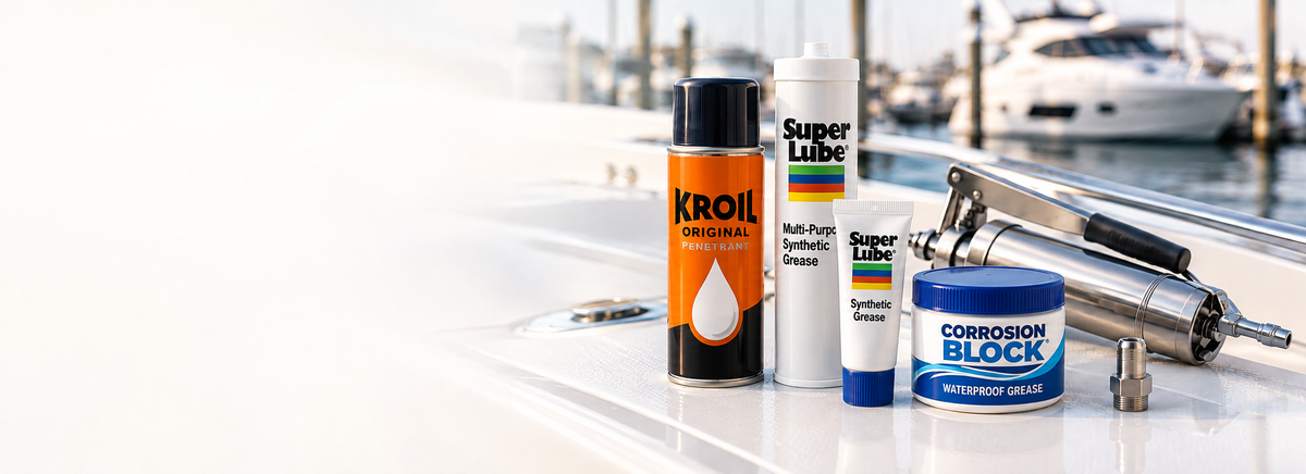 Kroil penetrating oil, Super Lube synthetic grease and Corrosion Block grease beside a grease gun on a yacht deck.