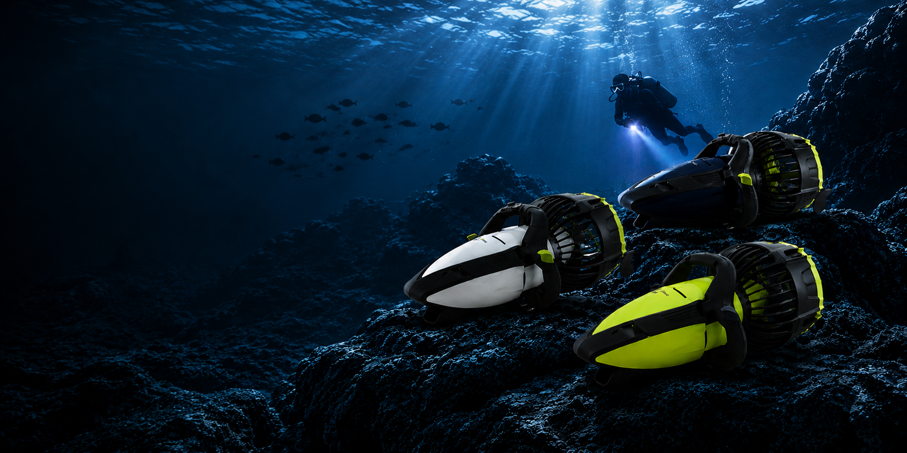 Scuba diver swimming in deep blue water above three underwater seascooters resting on a rocky reef bed.