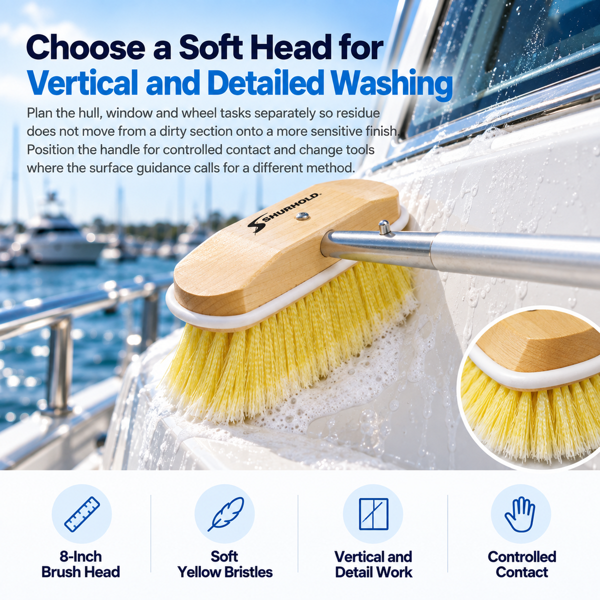 Shurhold 308 8-inch soft brush with yellow bristles and a wooden head washing a white boat surface below a cabin window.