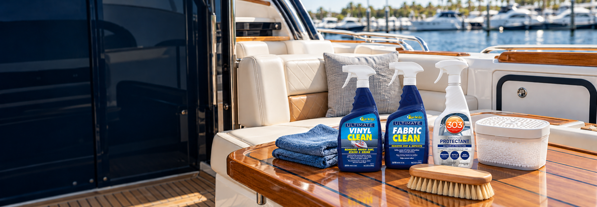 Star brite vinyl and fabric cleaners with 303 Aerospace Protectant on a teak table beside boat seating.